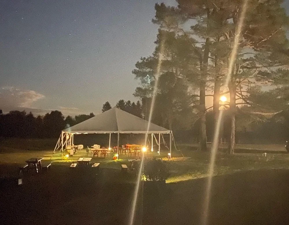 The party tent glowing at night