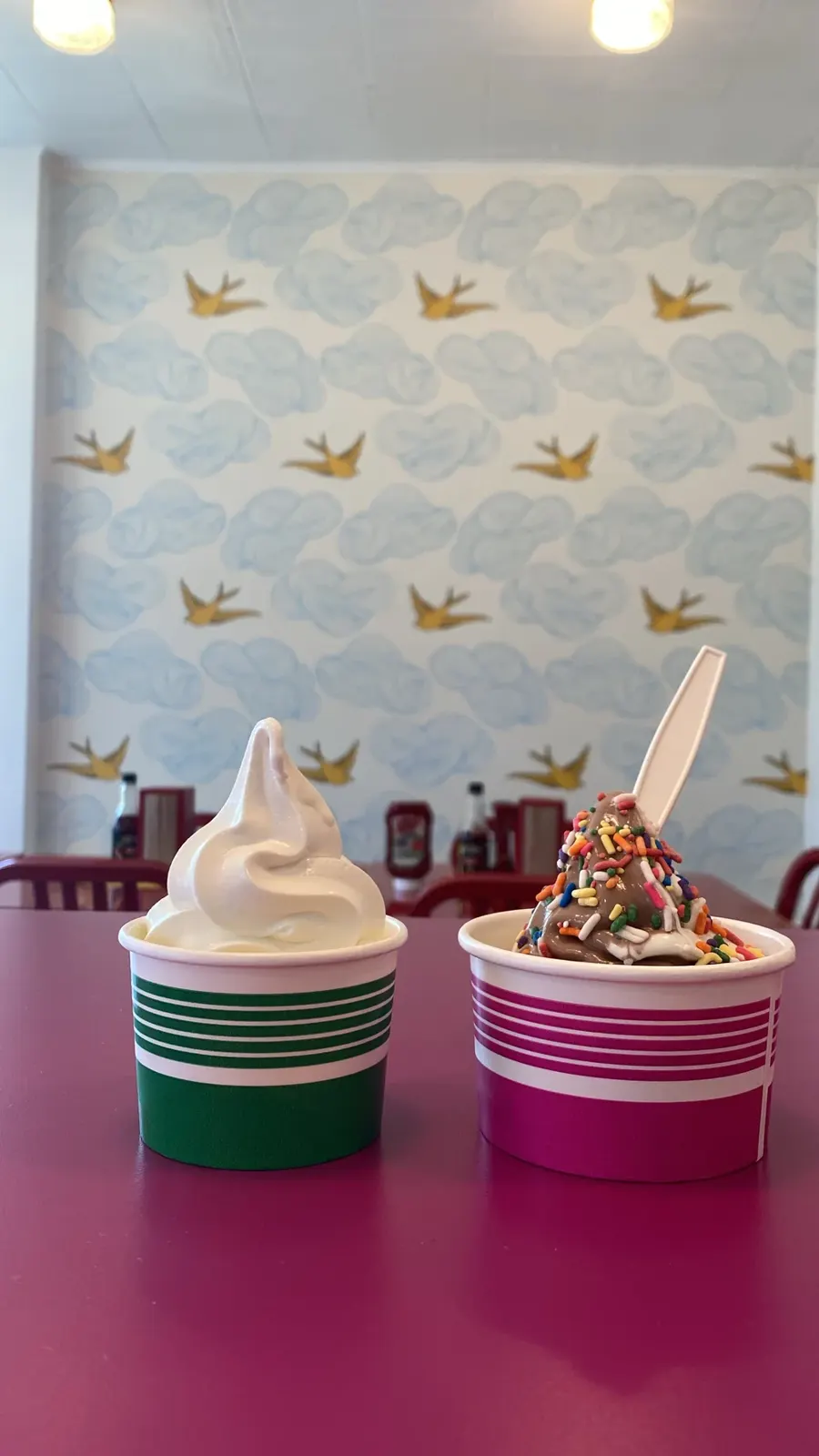 Two cups of soft serve in front of the swallow wallpaper
