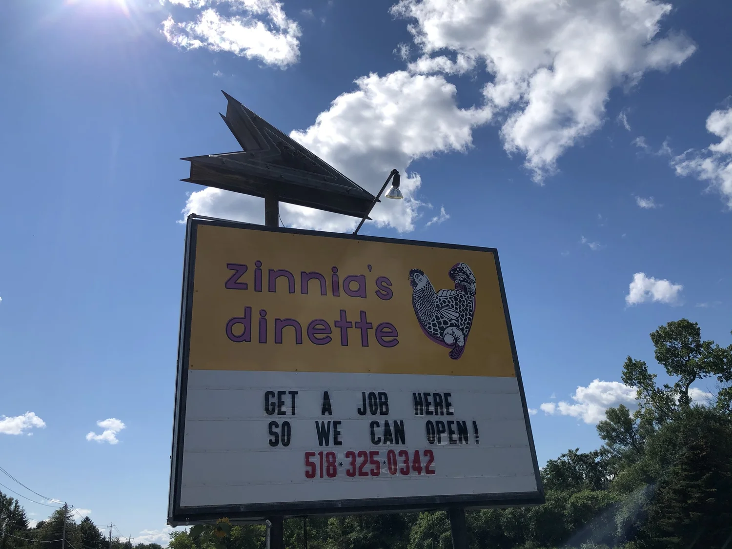 Zinnia's dinette roadside sign today, yellow with a chicken illustration
